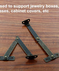 Antique Bronze Folding Lid Stay Hinges 2 Pack Left Side Lift Up For Furniture Cabinets Jewelry Boxes Display, shown on wood surface