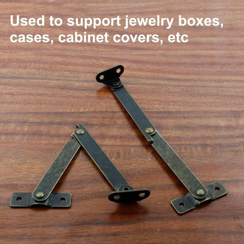 Antique Bronze Folding Lid Stay Hinges 2 Pack Left Side Lift Up For Furniture Cabinets Jewelry Boxes Display, shown on wood surface