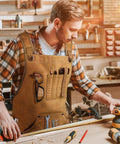 Man wearing Tough As Nails 20 Oz Waxed Canvas Woodworking Apron For Men With 9 Tool Pockets, Water Resistant And Dirt Proof, Khaki