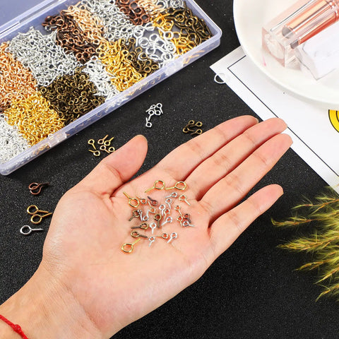 Hand holding multicolor mini eye screws from 1200 Pcs Small Screw Eye Pins For Pro DIY Jewelry Making Kit in 3 sizes