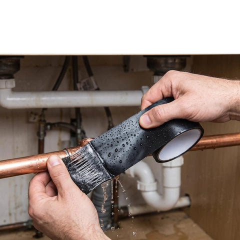 Heavy Duty Waterproof Duct Tape That Sticks Like Crazy For Indoor And Outdoor Repairs A Go To Home Fix For PVC Leaks Buckets And Plumbing Sealing Moisture Resistant Seal 4.9 Feet By 0.6 Inch being applied to a leaking copper pipe.