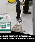 Pro Grade Food Service Cleaner And Degreaser For High Traffic Kitchens, Powers Through Grease And Food Residue, Easy On Routine Maintenance, NSF Registered A1 A2 A4 A8 B1 C1, 1 Gal bottle beside a person mopping floor