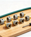 Rock Solid Garden Hose Repair Kit For 5/8 And 3/4 Inch Ends With Heavy Duty Aluminum Fittings And Zinc Clamps To Fix Leaks Fast On Taps Sprinklers And Outdoor Water Connections Like A Pro Now, seven hose connectors on wood board