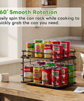 360 Degree Rotating Lazy Susan Can Organizer For Pantry Storage, Holds Twenty Six Cans, Black Smooth Spin Kitchen Rack with stacked cans on a wooden table.