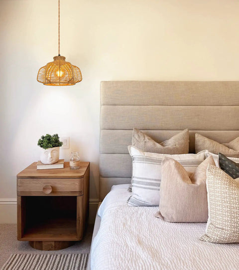 Rattan Hanging Light With Plug In Cord illuminating a cozy bedroom setup with boho wicker basket lamp shade and soft cushions.
