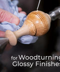 Applying finish to wooden object on lathe for woodturning glossy finishes.