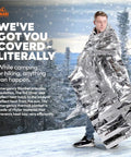 Person wrapped in Emergency Mylar Thermal Blanket from 10 Pack, standing in snowy forest. Giant space blankets 84x64 inches for survival.