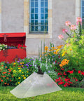 Windproof Dual Head Sprayer Nozzle Cover For Farm And Lawn Irrigation in a colorful garden setting