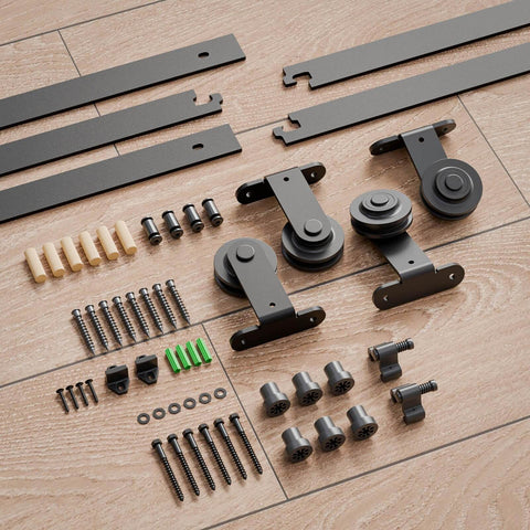 Heavy Duty 4Ft Bypass Sliding Barn Door Hardware Kit Built Tough For Two Doors Single Track System With Smooth Quiet Glide Top Mount Hangers Rust Resistant Black Steel Rail Ideal For Farmhouse Or Modern Living Spaces Door Not Included components including tracks and hangers spread on a wooden floor.