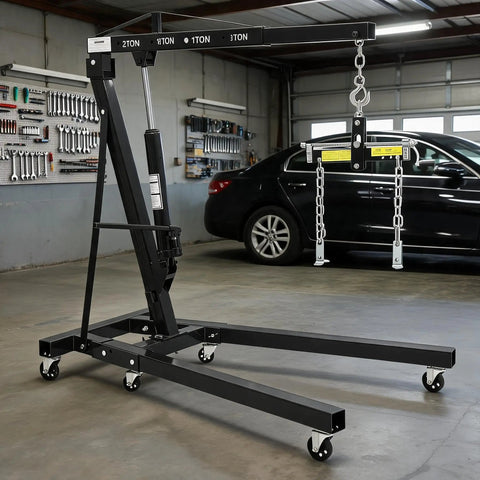 Bad Boy Heavy Duty Folding Hydraulic Engine Hoist And Cherry Picker in garage, designed for effortless lifting of 4400 pounds.