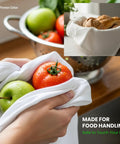 Person using Ultra Thick Cotton Dish Cloths 4 Pack 13x13 Inches for handling fruits and bread, showing absorbency and food safety.