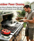 Man using the 2500W Handheld High Temperature Steam Cleaner on outdoor grill with steam and control knob visible.