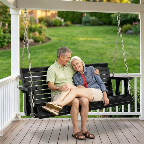 Couple sitting on Heavy Duty Outdoor Patio Porch Swing 880 Lbs Capacity 4ft Wooden Hanging Bench with Adjustable Chains, Black Finish