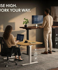 Top Notch Solid White Oak Electric Standing Desk With Dual Motor Height Adjustable System And Built Tough Steel Base For Easy Home Office Or Chill Creative Workspace Setup with a woman sitting and a man standing.