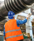Worker wearing Full Brim Hard Hat For Construction Crews, OSHA Safety Helmet, Lightweight HDPE in brilliant blue at an industrial site