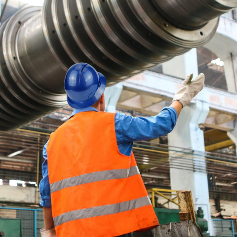 Worker wearing Full Brim Hard Hat For Construction Crews, OSHA Safety Helmet, Lightweight HDPE in brilliant blue at an industrial site