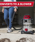 Person using Heavy-Duty 8-Gallon Stainless Steel Wet/Dry Vacuum With Boss-Level Suction in blower mode, outdoor setting