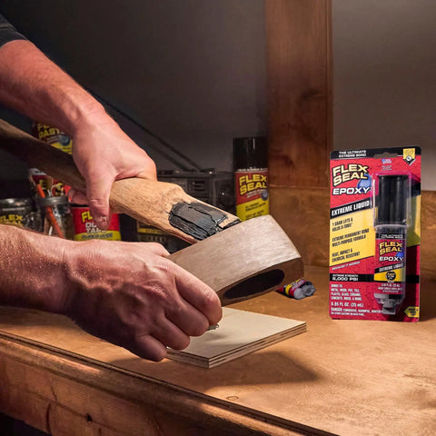 Applying Boss Level Liquid Epoxy Adhesive for ultimate waterproof fixes on a wooden hammer handle in a workshop.