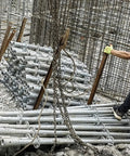 Kick Butt Heavy Duty Chain Lifting Sling 4 Leg 3 Ton 6614 Lbs Capacity with chains and hooks lifting pipes on construction site.