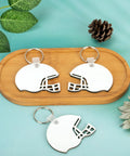 Helmet Shape Sublimation Keychain Blanks Kit, 20 Pieces With Rings And Clips for DIY with two keychains on wooden tray