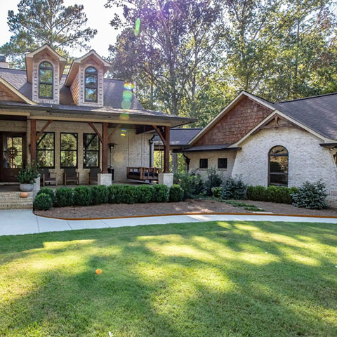 Front yard with Rolled Top Raw Lawn Edging Kit With Five 6 Inch By 94 Inch Steel Edging Pieces framing the garden beds.