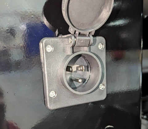 Close-up of the mounting outlet on 12V 10 Amp Panel Mount Battery Charger For Onboard Trickle Charging In Hydraulic Dump Trailers