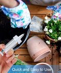 Gardener using Mini Seed Dispenser And Hand Seeder Tool For Garden Planters No Fuss Sowing Precise Seed Spreader for planting flowers.