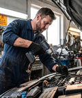 One Half Inch Flexible Shaft Extension With Universal Wrench Adapter Set 10 Inch And 14 Inch Heavy Duty Chrome Vanadium Tool in use by mechanic.