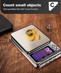 Ultra Portable Digital Coin Scale with coins and display on wooden table