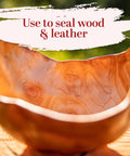 Straight Up Pure Carnauba Wax Flakes For Smooth Skin Care And Lip Balm Making Real Deal Vegan Candle Wax With Leather And Wood Finish Must Have DIY Staples Eight Ounce Bag in a wooden bowl.