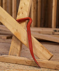 30-Inch Steel Wrecking Bar Heavy Duty Demolition Pry Tool for Contractors and DIY Pros Built Tough for Industrial and Home Use Meets ANSI and ASME Specs demonstrating leverage on wooden beams