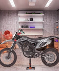 Heavy Duty Dirt Bike Lift Stand With 440 Lb Capacity And Hydraulic Lift holding a dirt bike in a garage setting