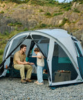 Six Person Family Camping Tent With Screen Porch Weatherproof All Season Large Cabin Style Shelter setup outdoors by a river