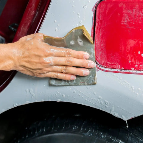 Hand using Pro-Grade 1000 Grit Wet Or Dry Sandpaper Sheets 5-1/2 X 9 In Box Of 25 For Car Color Sanding on vehicle panel