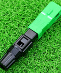 SC/APC fiber optic quick-connect adapter, green housing with black plug for CATV networks