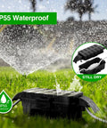 IP55 Weatherproof Outdoor Electrical Box With Detachable Awning UL Listed Compact 5.9 By 3.2 By 1.8 Inch Inner Space Extension Cord Cover For Plugs Outlets And Holiday Lights Black in grass under sprinkler showing waterproof feature.