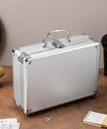Kickass Top Notch Heavy Duty Aluminum Alloy Tool Case With Custom Foam Insert Hard Shield For Cameras Cosmetics And Small Tech Gear Portable Metal Briefcase Pro on a desk.