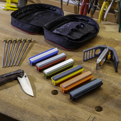 All In One Knife Sharpening Kit That Seriously Handles 6 Stones For Straight And Serrated Blades Angle Guide Portable Storage Pouch And Hook Sharpener Great For Kitchen Hunting Fishing And Pocket Knives on a table