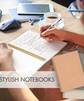 Person writing in one of the Stylish Aesthetic Spiral Notebook Set Of 3 For Women with open pages and other notebooks in view