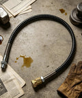 Built Tough Flexible Air Hose For Compressor 20 Inch Anti Knot Pneumatic Tubing with brass fittings on a workshop surface.