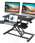 Epic Height Adjustable Sit To Stand Desk Converter for dual monitors and laptop with 31.5 inch wide top surface in use