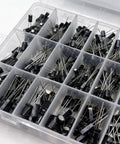 Plastic container with assorted capacitors from Must Have 680 Piece Electrolytic Capacitor Kit With 24 Sizes Ranging From 0.1uF To 1000uF In 16V 25V And 50V Aluminum Radial Lead Capacitors For DIY Electronics Repair Projects And Pro Hobbyist Upgrades