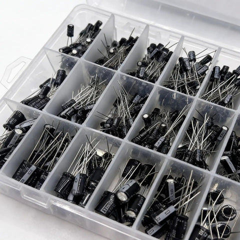 Plastic container with assorted capacitors from Must Have 680 Piece Electrolytic Capacitor Kit With 24 Sizes Ranging From 0.1uF To 1000uF In 16V 25V And 50V Aluminum Radial Lead Capacitors For DIY Electronics Repair Projects And Pro Hobbyist Upgrades