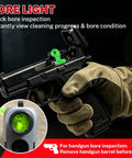 Gloved hand holding handgun with bore light, part of 80 Piece Gun Cleaning Kit For Handguns Rifles Calibers.22.357.38 9mm.40.45