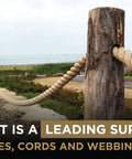 Tan Twisted 3 Strand Polypropylene Rope 1 Inch By 100 Feet used as a fence on wooden posts by the beach.