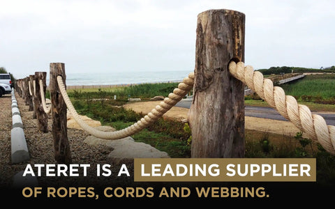 Tan Twisted 3 Strand Polypropylene Rope 1 Inch By 100 Feet used as a fence on wooden posts by the beach.