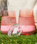 Freezable Stemless Wine Glasses With Secure Lids, Double Wall Insulated Chiller Tumblers For Grab And Go Vibes, Keep Your Sip Ice Cold Outside, 12 Oz Set Of Two Pink Blush Drinkware For Her on grass with water.