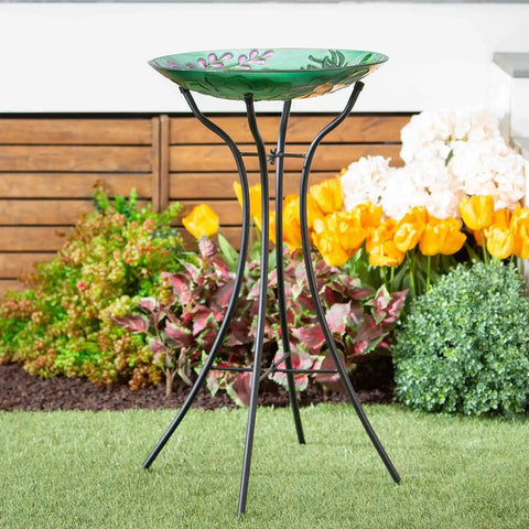 Hourglass Metal Bird Bath Stand For Outdoors No Fuss Setup Weatherproof 31 Inch Tall Fits Up To 18 Inch Diameter Bowls Easy Assembly Four Stable Steel Legs For Garden Patio Yard Year Round Use supporting a decorative bowl amidst garden flowers