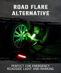 Man using green emergency glow sticks as road flare alternative during nighttime vehicle repair