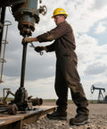 Man wearing Waterproof Steel Toe Work Boots For Men Paladin-Steel working on industrial machinery outdoors